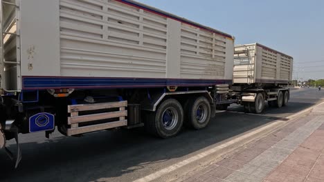 a large truck drives down a country highway.