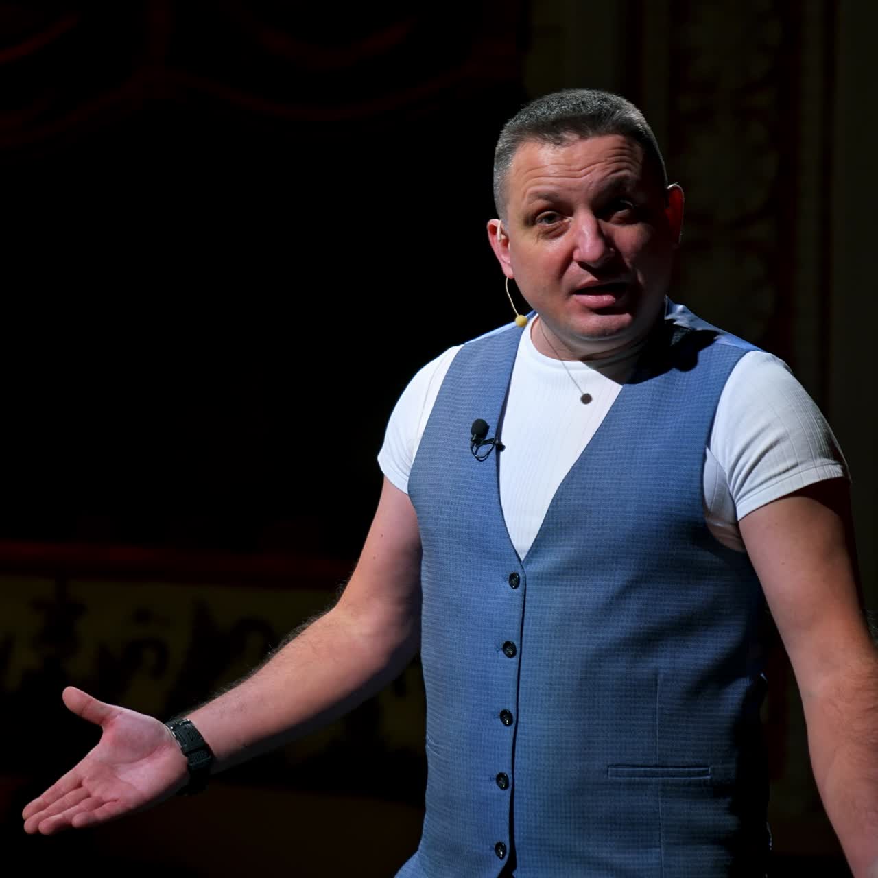Actor on classic theatre stage. Man is speaking in spotlights during the performance. Side view video