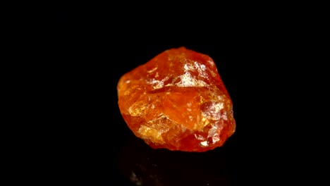 seamlessly rotating a mineral (mandarin granat) in front of black background