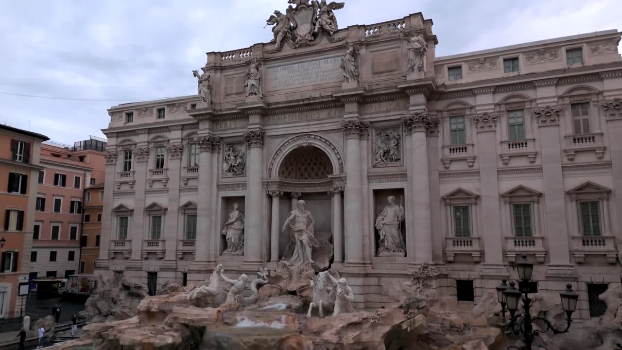 Picturesque rising aerial of Trevi Fountain, close up view in the early morning cloudy day in Rome, Italy
