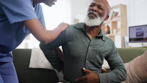 nurse assisting senior with back pain