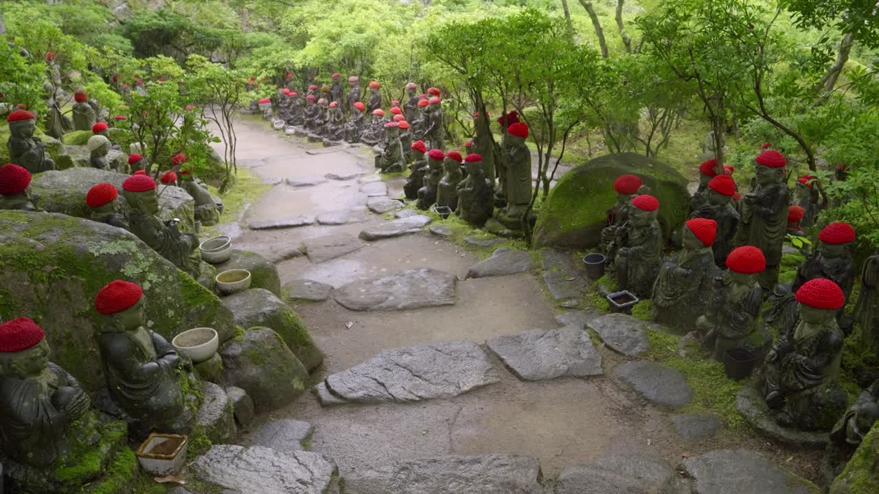 Beautiful Jizo statues flanking stone paths at Japanese temple