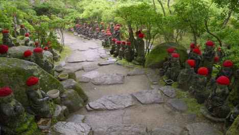 beautiful jizo statues flanking stone paths at japanese temple