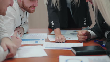 office workers are discussing plan of development business in meeting closeup of table with charts