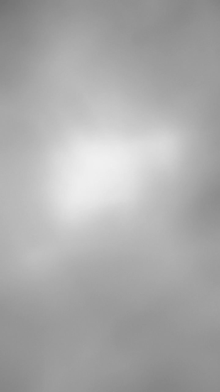 Light grey wavy lights flowing in an abstract pattern. Vertical background.