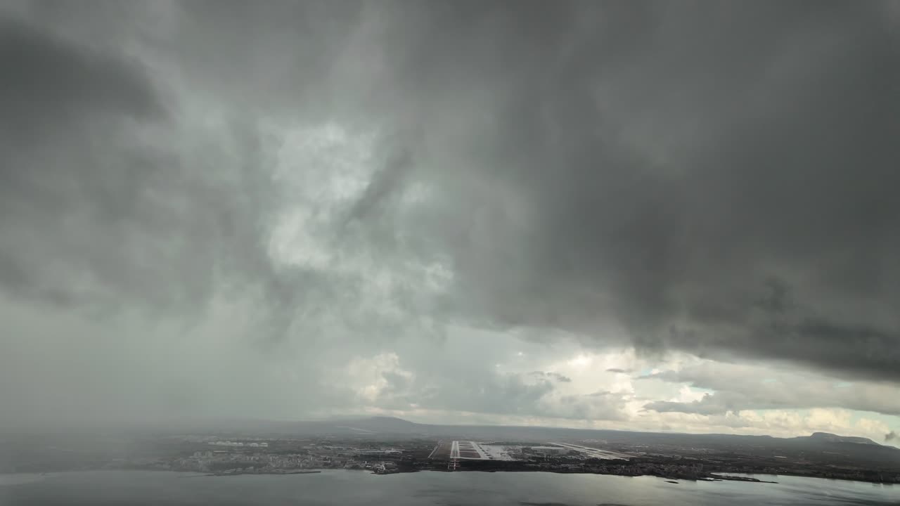 Immersive pilot’s perspective FPV in a real time approach to Palma de Mallorca airport runway at the eyes of the pilots while flying through a stormy sky with rain. 4K 60FPS