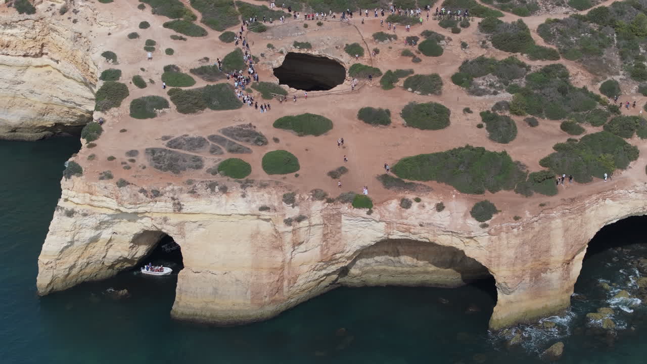 Aerial drone view of the Benagil Sea Cave and Atlantic Ocean coastline in Algarve, Portugal, Europe. Natural landform by Sette Vales hiking trail