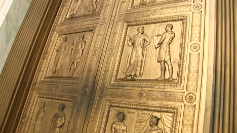 close view panup of the bronze sculptures on the west entrance doors of the supreme court