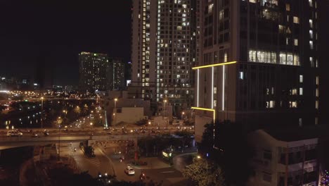 aerial-tripod-view-across-busy-traffic-bridge-and-underpass-at-night