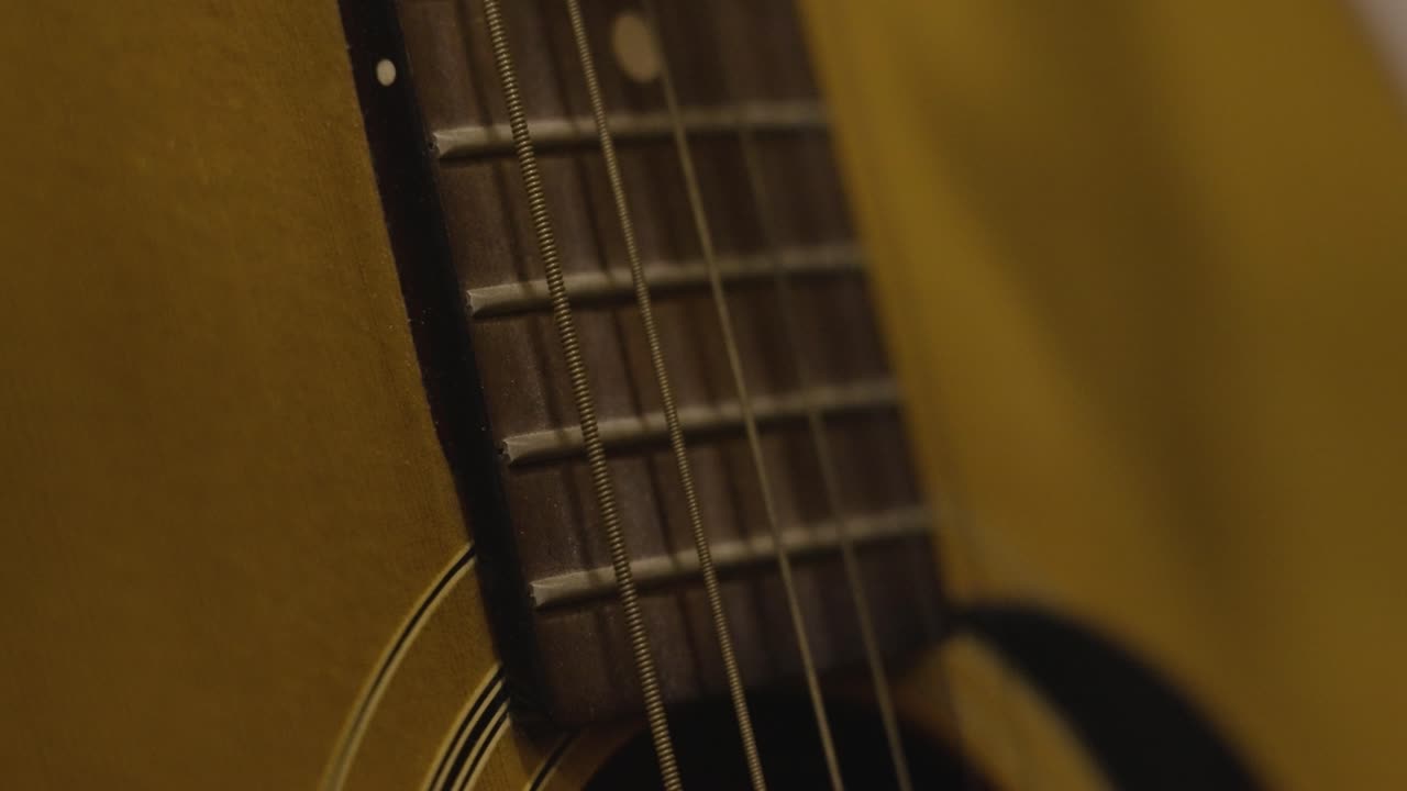 An old acoustic guitar shot in slow motion
