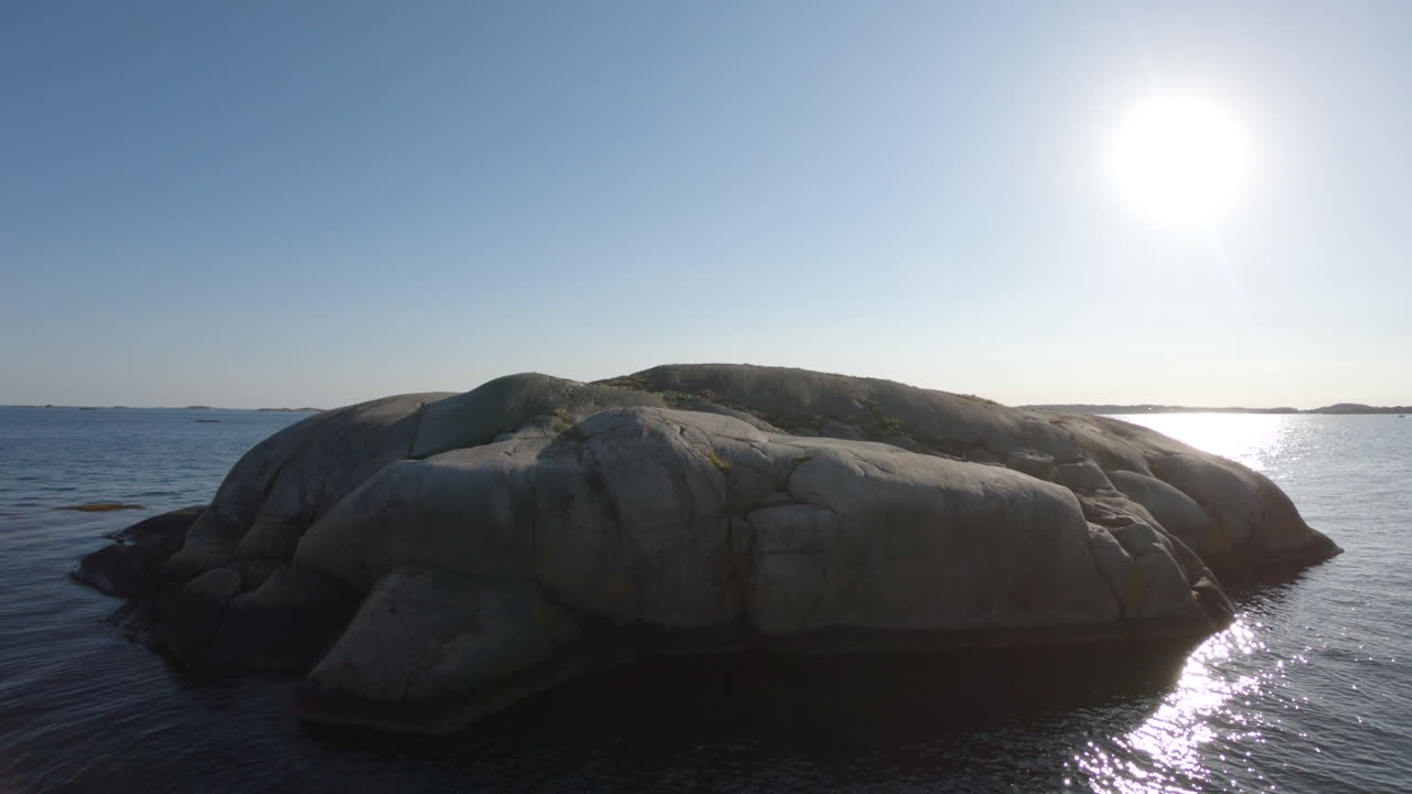 4k Shot of a big lonely rock in the blue ocean sea outside Gothenburg, Sweden