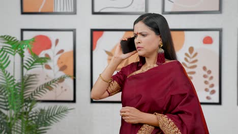 Serious-Indian-woman-talking-on-a-call