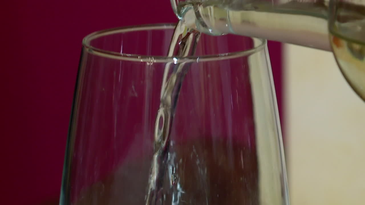 Water being poured into a wine glass