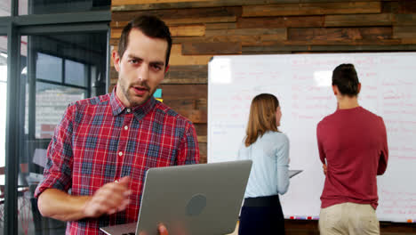 Male-executive-using-laptop-in-the-conference-room