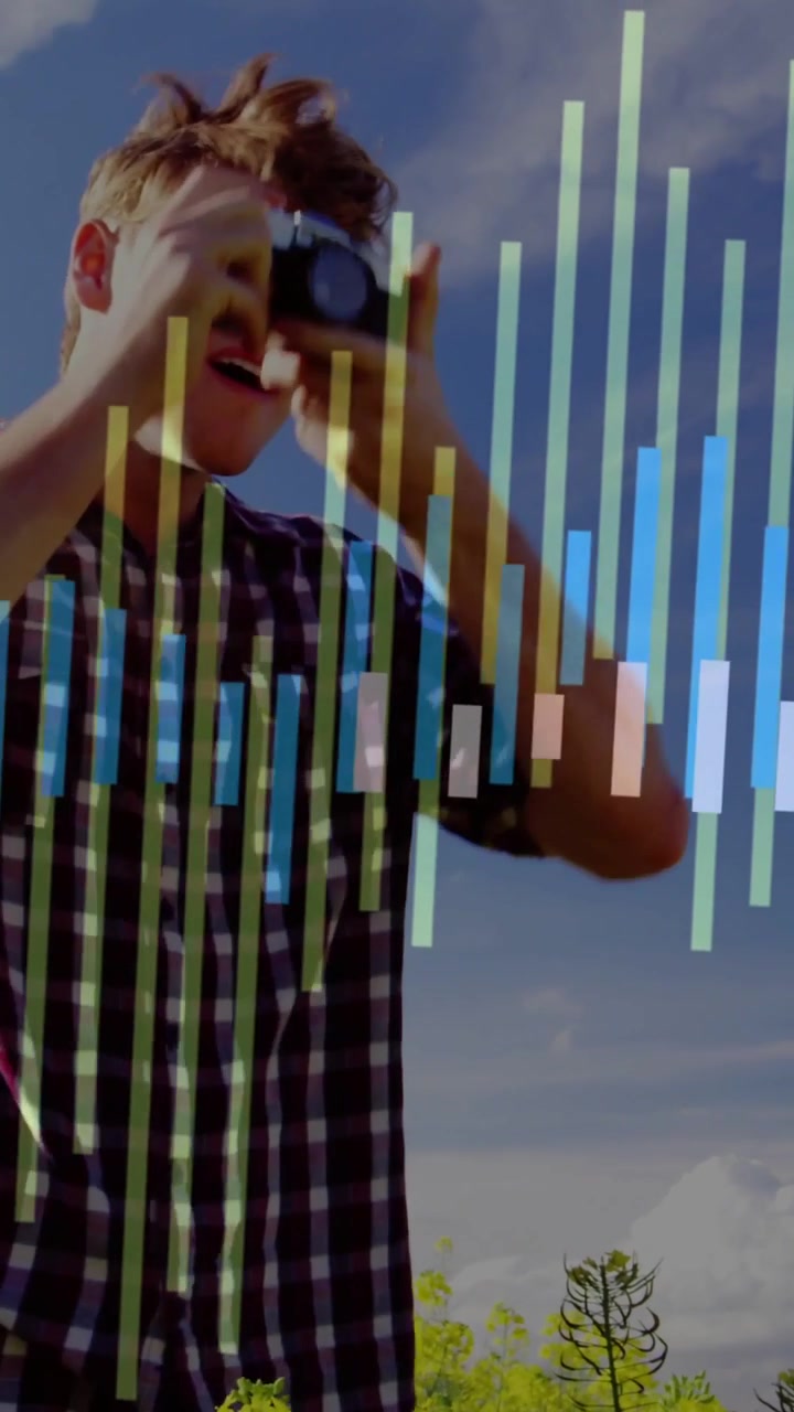 Vertical video: Man entering frame tuning camera and shooting yellow field, initiating EQ bars