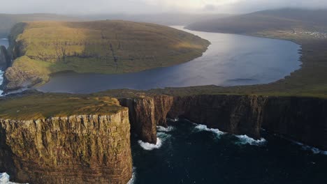 very far approaching drone footage of the leitisvatn lake, aka the floating lake, on the vagar island in the faroe islands