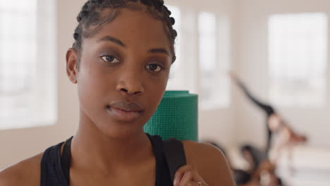 portrait-beautiful-yoga-woman-smiling-confidently-african-american-female-enjoying-healthy-lifestyle-with-people-practicing-in-fitness-studio-background