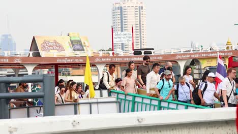 people boarding a ferry on chao phraya river