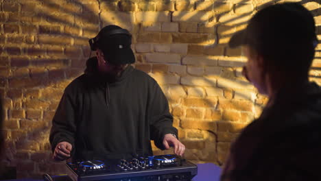 man with headphones djing at the disco