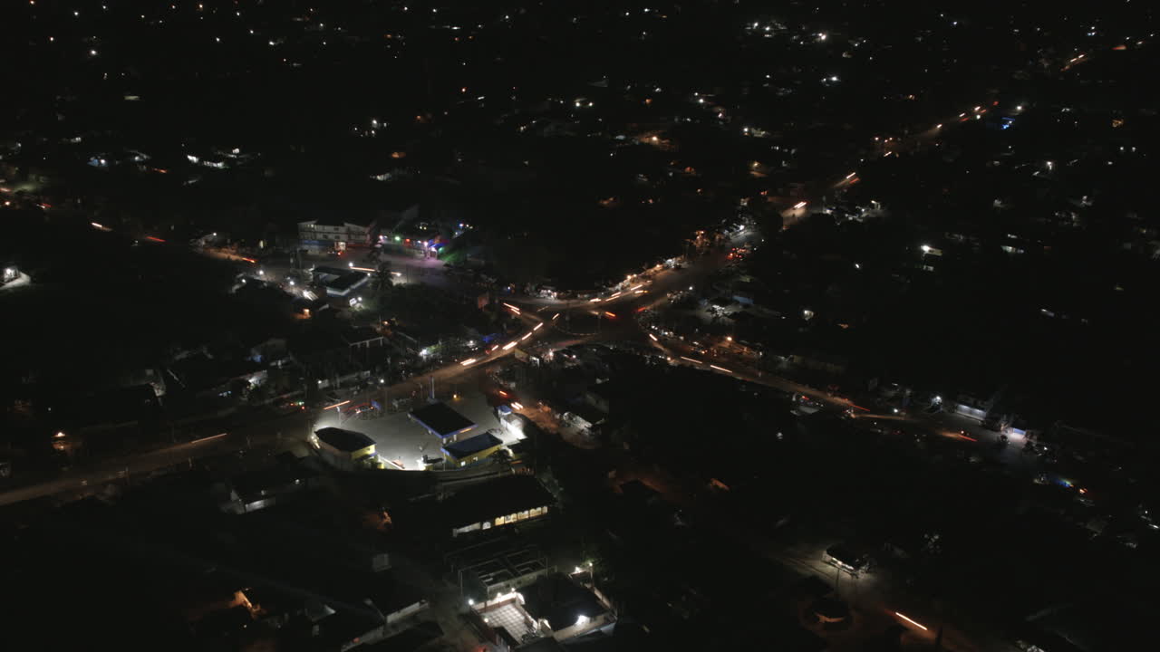 Aerial hyperlapse at night of a busy intersection and roundabout with lots of traffic in Bo, Sierra Leone, Africa.