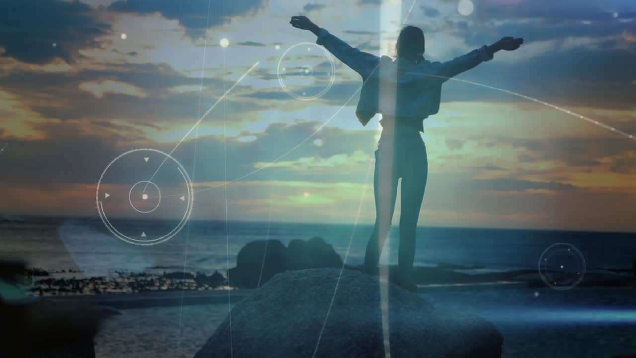 Woman traveler standing on rock facing ocean, showcasing floating HUD elements for technology
