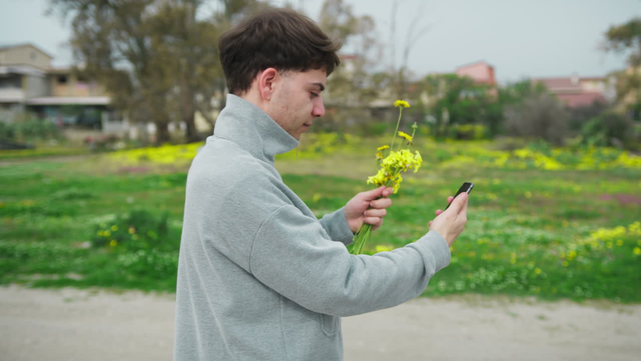 Man Showing Flowers To His Loved One While Having A Videocall Outdoor