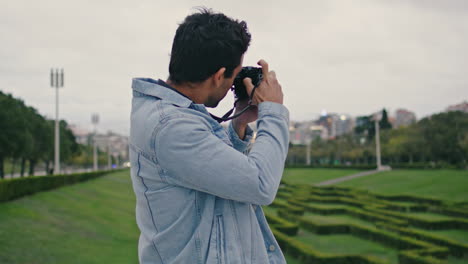 creative photographer shooting nature park at summer evening closeup back view