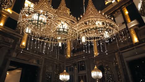 weihnachtslichter hängen von kronleuchtern in einer für die feiertage geschmückten luxushotellobby