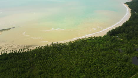 wide angle aerial pullback reveals stunning crescent bay beach in khao lak thailand