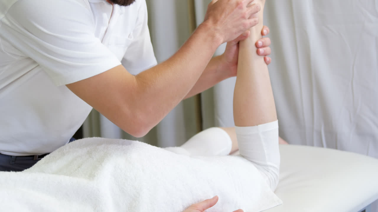 Physiotherapist giving hip massage to a woman