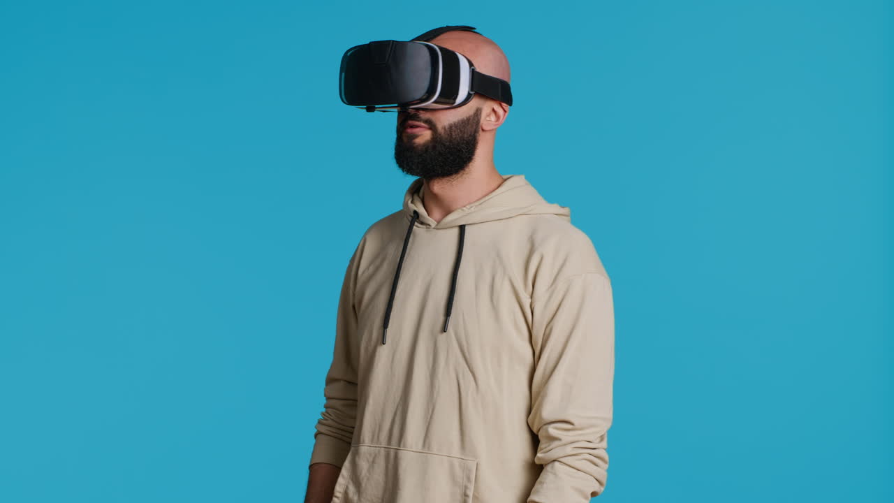 Middle eastern adult using virtual reality glasses in studio