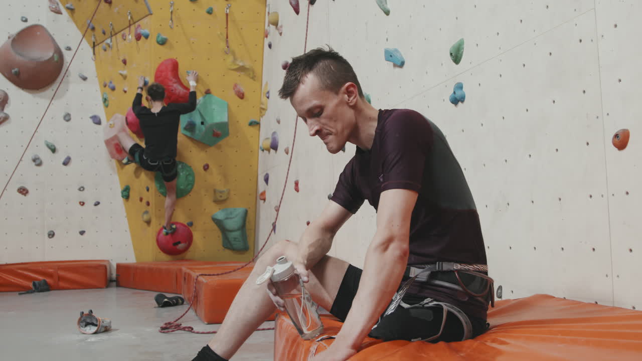 Male Athlete With Amputated Leg Resting After Indoor Wall Climbing