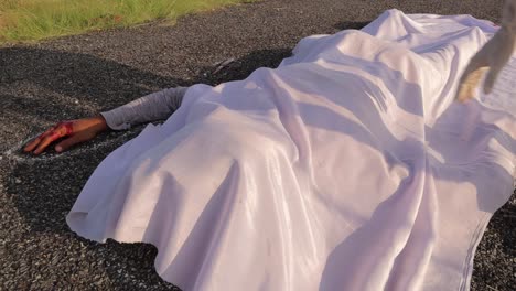 concept of crime scene road accident, close up of covering chalk outlined dead body on road