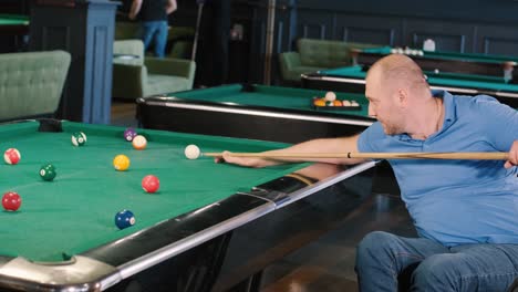 adult men with disabilities in a wheelchair play billiards in the club