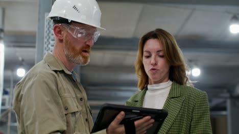 factory employee discussing project with manager