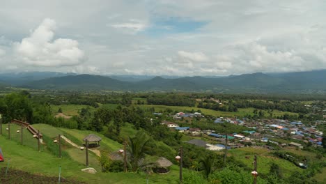 Panoramic-view-from-Yun-Lai-Viewpoint-overlooking-the-picturesque-landscape-of-Pai,-Thailand,-with-mountains-in-the-distance