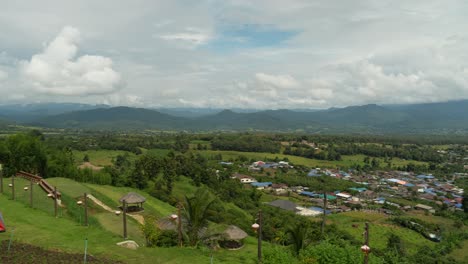 panoramic view from yun lai viewpoint overlooking the picturesque landscape of pai, thailand, with mountains in the distance