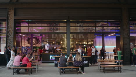 people drinking and eating at lakeside shopping centre in essex