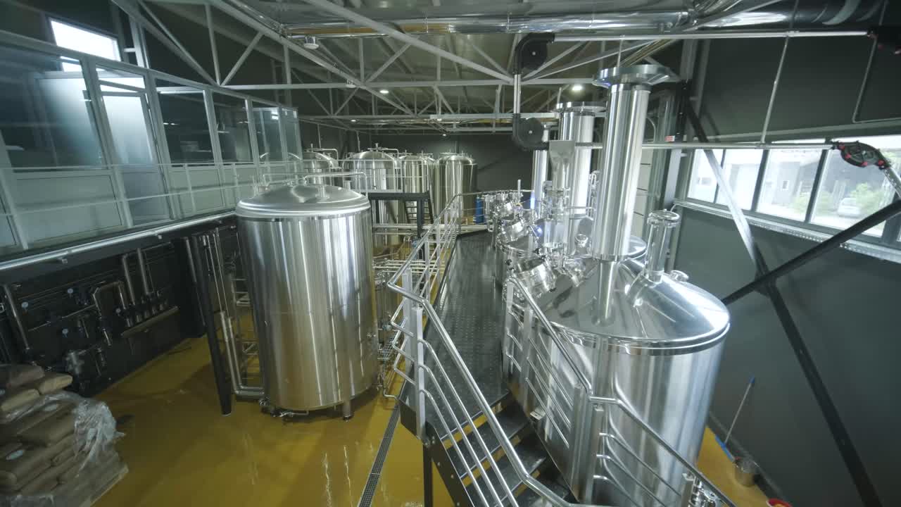 Pabrik bir kerajinan modern. Produksi bir kerajinan. Peralatan modern di pabrik bir, tangki logam, produksi minuman beralkohol