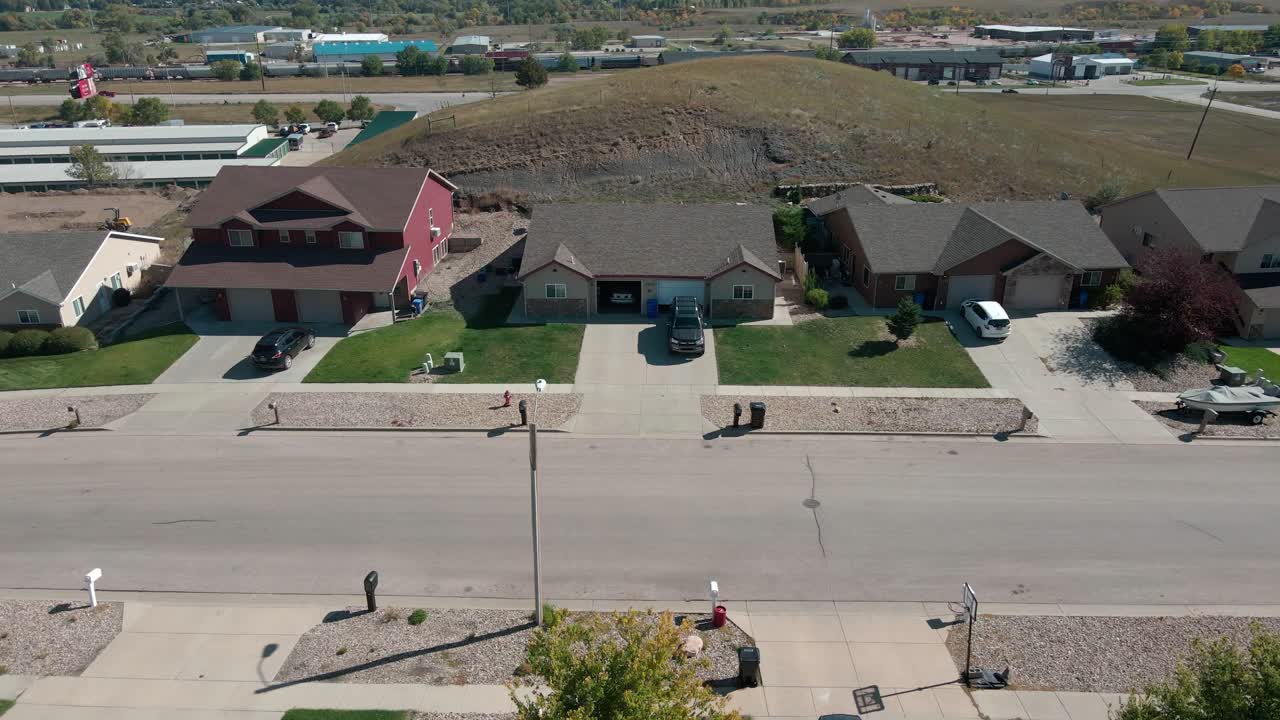 Aerial shot moving down a street revealing houses