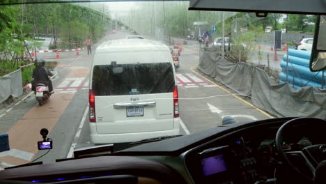 rainy day traffic in city - view from a bus