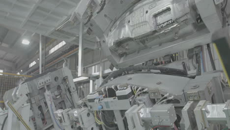 automobile cars plant automated engine assembly a vehicle body, press a metal steel sheet in factory to makes the car parts