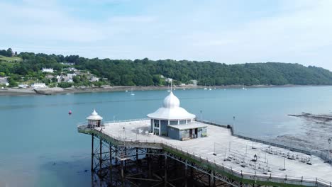 Bangor-seaside-pier-North-Wales-silver-spire-pavilion-low-tide-aerial-view-slow-rising-tilt-down-shot