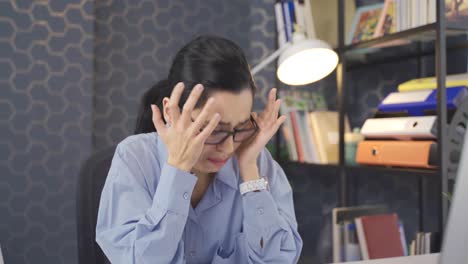 young business woman working on computer in office is worried.