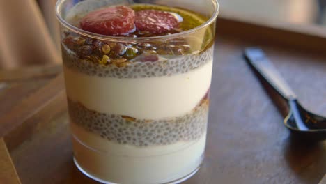 chia pudding with yogurt, granola, strawberries and honey