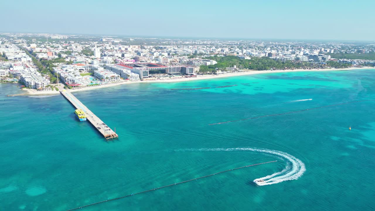 Stunning aerial shot of Playa del Carmen beach, clear waters, pier, and cityscape