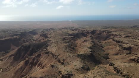 drone aerial pan right over the ridges of the charles knife gorge with the landscape and clouds