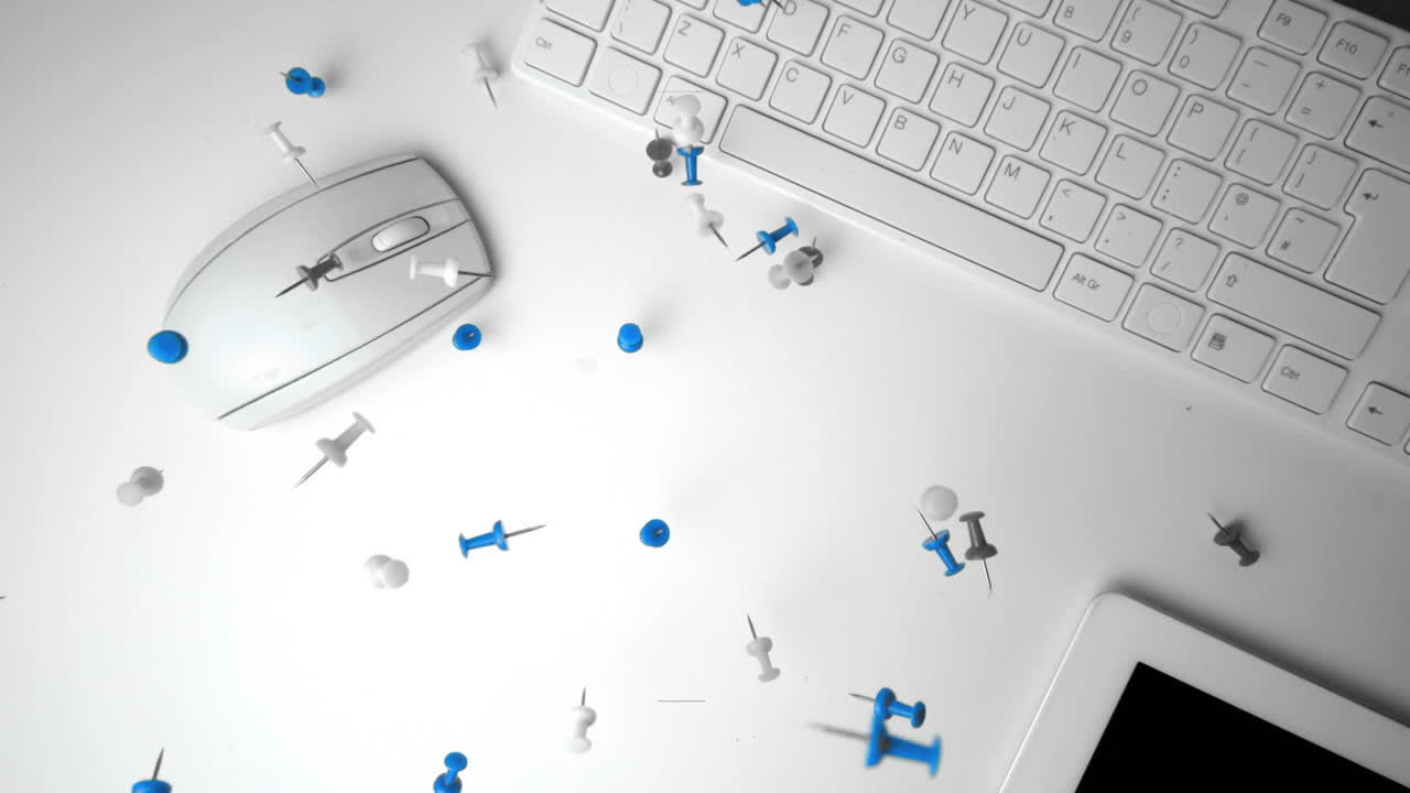 Group of pushpins falling on office desk