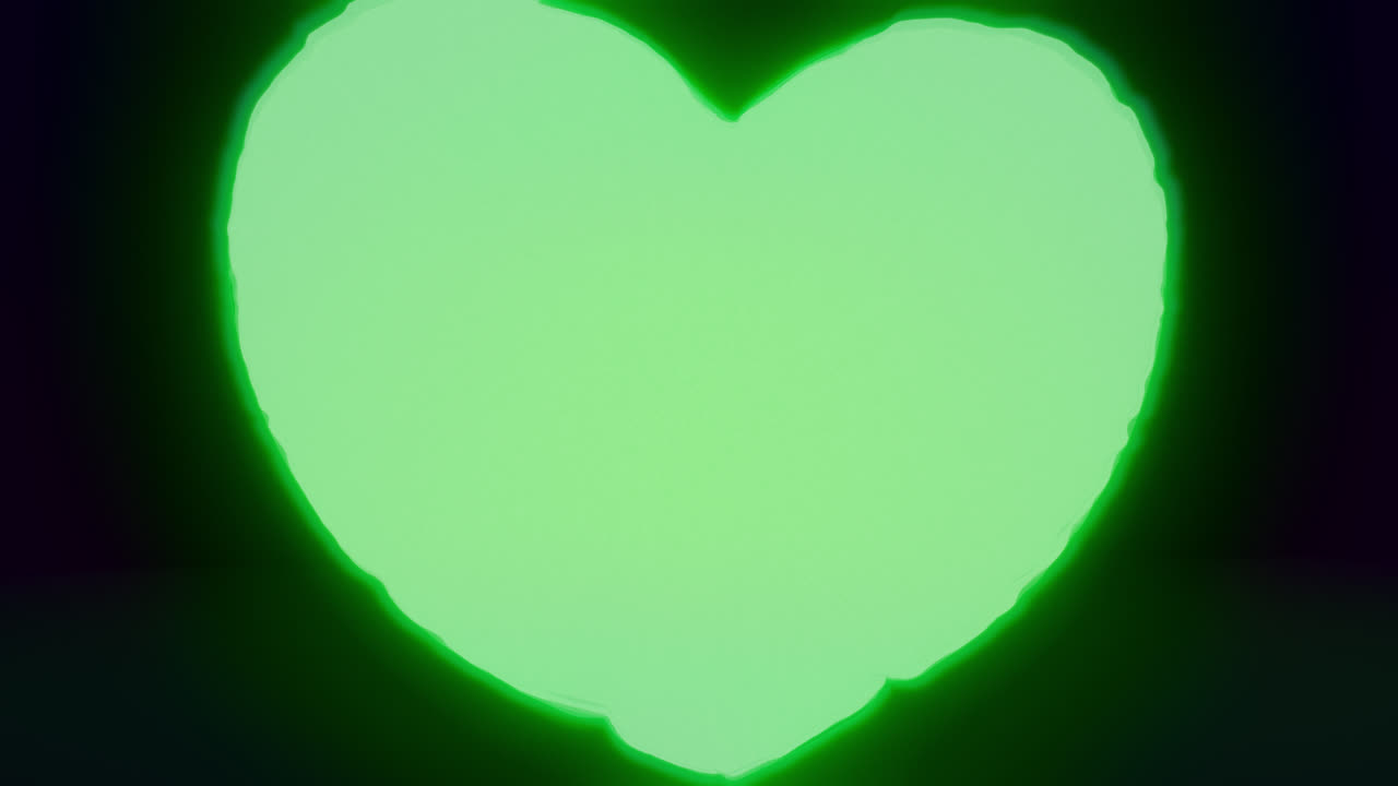 Green energy heart shapes on a dark background