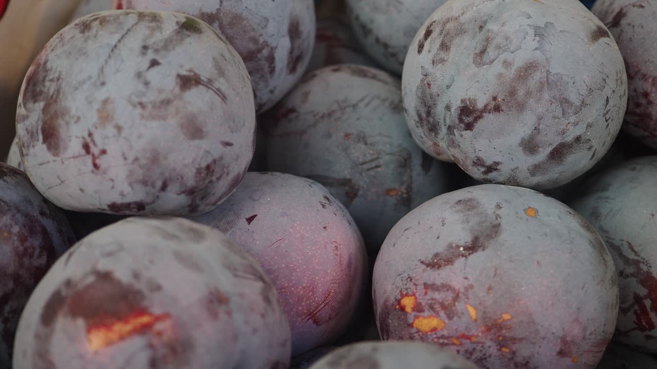 A close-up of a pile of plums